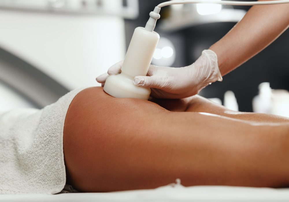 Shot of an unrecognizable woman getting anti cellulite massage at the beauty salon. She have an ultrasound cavitacion treatment to fat reduction.